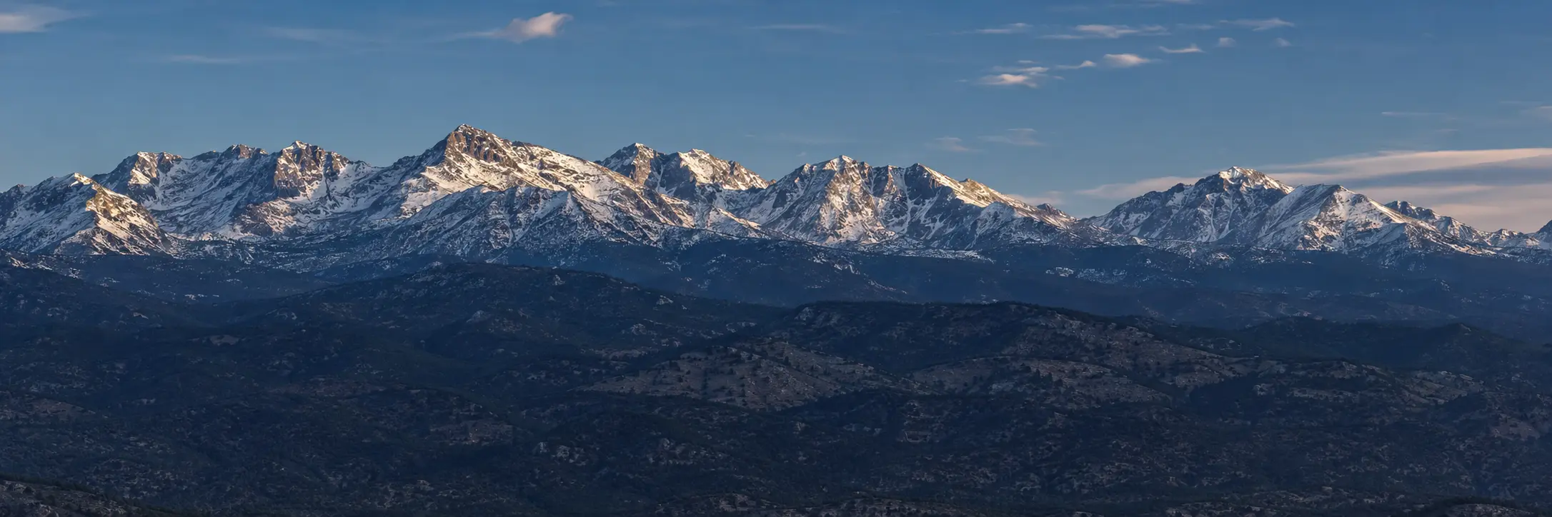 Snow-capped Colorado Front Range mountains in clear afternoon light